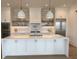 Gourmet kitchen boasts a center island, custom white cabinetry, and stainless steel appliances at 305 Matilda St, Edisto Beach, SC 29438