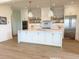 Modern kitchen featuring a large island, stainless steel appliances, and stylish white cabinetry at 305 Matilda St, Edisto Beach, SC 29438