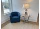 Comfortable blue armchair with decorative lamp and table next to the bright window at 305 Matilda St, Edisto Beach, SC 29438