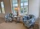 Cozy living area with two armchairs, side table, lamp, and view from the windows at 305 Matilda St, Edisto Beach, SC 29438