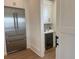 Kitchen pantry with a wine cooler, cabinetry, and a stainless steel refrigerator at 305 Matilda St, Edisto Beach, SC 29438
