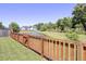 Picturesque backyard with a wooden fence, pond view, and mature trees at 308 Legendres Dr, Goose Creek, SC 29445