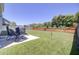 Large backyard with a concrete patio, wooden fence, and lush green grass at 308 Legendres Dr, Goose Creek, SC 29445