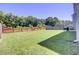 Large backyard featuring a wooden fence, ample grass, and a grill area at 308 Legendres Dr, Goose Creek, SC 29445