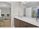 Bathroom with a white countertop, wood cabinets, large mirror, and a view into the bedroom at 308 Legendres Dr, Goose Creek, SC 29445
