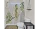 Well-lit bathroom features a toilet, tropical-themed shower curtain, and convenient storage at 308 Legendres Dr, Goose Creek, SC 29445