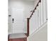 Hallway with staircase and white walls next to a door with a welcome mat on the hardwood floor at 308 Legendres Dr, Goose Creek, SC 29445