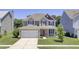 Charming two-story home with a well-manicured lawn, two-car garage, and inviting red front door at 308 Legendres Dr, Goose Creek, SC 29445