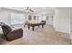 Spacious game room features a billiard table, ceiling fan, two windows, and a leather sofa for entertaining at 308 Legendres Dr, Goose Creek, SC 29445