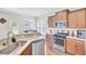 Well-equipped kitchen with granite countertops, stainless steel appliances, and wood cabinets at 308 Legendres Dr, Goose Creek, SC 29445