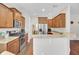 Modern kitchen with hardwood floors, stainless steel appliances, granite countertops, and wooden cabinetry at 308 Legendres Dr, Goose Creek, SC 29445
