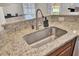 Close-up of kitchen sink with granite countertop, stainless steel fixtures, and modern design at 308 Legendres Dr, Goose Creek, SC 29445