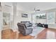 Cozy living room featuring hardwood floors, comfortable seating, ceiling fan, and a large television at 308 Legendres Dr, Goose Creek, SC 29445