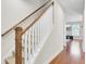 Bright staircase featuring carpeted steps, wood handrail, and white spindles in a home with hardwood flooring at 308 Legendres Dr, Goose Creek, SC 29445