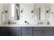 Modern bathroom featuring double sinks, brushed gold sconces, and sleek gray cabinetry at 3139 Vanessa Lynne Ln, Johns Island, SC 29455