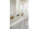 Bright bathroom featuring a double sink vanity with gold fixtures and gray cabinets at 3139 Vanessa Lynne Ln, Johns Island, SC 29455