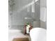 Modern bathroom features a frameless glass shower, soaking tub, and light gray tile at 3139 Vanessa Lynne Ln, Johns Island, SC 29455