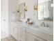 Bright bathroom featuring double sink vanity, marble countertop, gold fixtures, and stylish mirrors at 3139 Vanessa Lynne Ln, Johns Island, SC 29455
