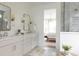Bright bathroom featuring a double sink vanity, modern lighting, glass shower, and doorway to the bedroom at 3139 Vanessa Lynne Ln, Johns Island, SC 29455