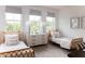 Bright bedroom featuring matching twin beds, neutral walls, and modern light fixtures at 3139 Vanessa Lynne Ln, Johns Island, SC 29455