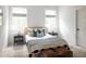 Bright bedroom features a striped throw blanket, neutral rug, and two leather ottomans at 3139 Vanessa Lynne Ln, Johns Island, SC 29455