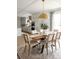 Elegant dining area featuring a wood table, seating for six, and a gold pendant light at 3139 Vanessa Lynne Ln, Johns Island, SC 29455