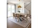 Elegant dining area featuring a wood table, seating for six, and a gold pendant light at 3139 Vanessa Lynne Ln, Johns Island, SC 29455