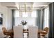 Bright dining room with modern lighting, beautiful hardwood table, decorative chairs, and large window at 3139 Vanessa Lynne Ln, Johns Island, SC 29455