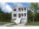 Charming two-story home with a inviting front porch, featuring a classic exterior, set amidst lush greenery at 3139 Vanessa Lynne Ln, Johns Island, SC 29455