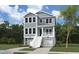 Charming two-story home with a inviting front porch, featuring a classic exterior, set amidst lush greenery at 3139 Vanessa Lynne Ln, Johns Island, SC 29455