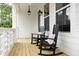 Inviting front porch featuring rocking chairs, offering a relaxing outdoor space with classic lanterns at 3139 Vanessa Lynne Ln, Johns Island, SC 29455