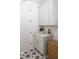 Well-organized laundry room with white cabinets, quartz countertops, and stylish star patterned flooring at 3139 Vanessa Lynne Ln, Johns Island, SC 29455