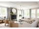 Bright living room with a fireplace, large windows, stylish furnishings and a modern chandelier at 3139 Vanessa Lynne Ln, Johns Island, SC 29455
