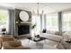 Cozy living room featuring a tiled fireplace, large mirror, and a comfortable seating area with stylish decor at 3139 Vanessa Lynne Ln, Johns Island, SC 29455