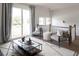 Light-filled sitting area with two gray chairs, a neutral rug, and access to a balcony at 3139 Vanessa Lynne Ln, Johns Island, SC 29455