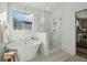 Bright bathroom featuring a modern soaking tub and a glass-enclosed shower with tiled walls at 3143 Vanessa Lynne Ln, Johns Island, SC 29455