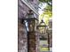 Exterior wall lights adorn a brick wall near a black iron fence at 3143 Vanessa Lynne Ln, Johns Island, SC 29455