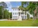 Charming two-story home featuring double front porches, white siding, and manicured landscaping at 3143 Vanessa Lynne Ln, Johns Island, SC 29455