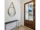 Bright foyer with a wood door, stylish round mirror, black table, and light wood flooring at 3143 Vanessa Lynne Ln, Johns Island, SC 29455