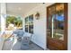 Inviting front porch with rocking chairs, wood door, and white pillars, offering a cozy outdoor space at 3143 Vanessa Lynne Ln, Johns Island, SC 29455