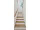 Staircase with wooden steps, white risers, and natural light coming from a window at 3143 Vanessa Lynne Ln, Johns Island, SC 29455