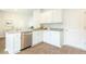 Stylish kitchen featuring stainless steel appliances, granite countertops, white cabinets and wood floors at 317 Salvia Sq, Moncks Corner, SC 29461