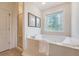 Bright bathroom featuring a soaking tub with decorative window and a glass-enclosed shower at 3331 Cottonfield Dr, Mount Pleasant, SC 29466