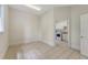 An empty bonus room leads to a laundry room complete with tile flooring and base molding at 3331 Cottonfield Dr, Mount Pleasant, SC 29466