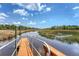 Scenic view of the tranquil waterway from the end of the wooden dock under a sunny sky at 3331 Cottonfield Dr, Mount Pleasant, SC 29466