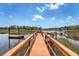 A long wooden dock extending into the tranquil waterway with views of marsh grass at 3331 Cottonfield Dr, Mount Pleasant, SC 29466