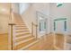 Bright two-story foyer with wood floors, staircase, and arched entryways to other rooms at 3331 Cottonfield Dr, Mount Pleasant, SC 29466