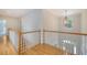 Upstairs hallway with wood flooring and staircase views to the two floors below at 3331 Cottonfield Dr, Mount Pleasant, SC 29466