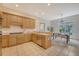 Bright kitchen featuring wood cabinets, a stainless steel dishwasher, and an adjacent dining area with patio access at 3331 Cottonfield Dr, Mount Pleasant, SC 29466