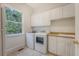 Laundry room featuring a sink, washer, dryer, and ample cabinet space with a window at 3331 Cottonfield Dr, Mount Pleasant, SC 29466